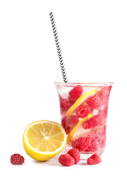 Glass of fresh raspberry lemonade on white background