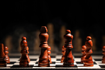 Game board with chess pieces on dark background, closeup