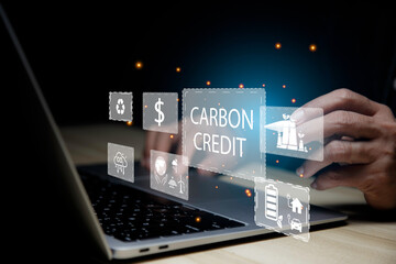 Businessman using laptop analyzing data Carbon Credit Market ,Net zero in 2050 year for ESG eco concept environmental, social, sustainable, ethical. eco green energy system icon around it..