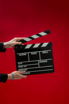 Crop person with clapperboard
