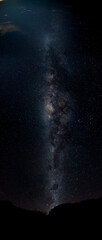 The Milky Way Galaxy moving over the mountain ridge. Night lapse from night to day. Starry night.