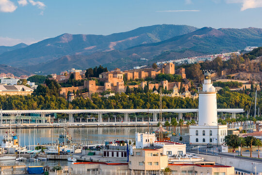 Malaga, Spain townscape with the lighthouse and Alcazaba.