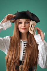 Beautiful female pirate with skull on green background