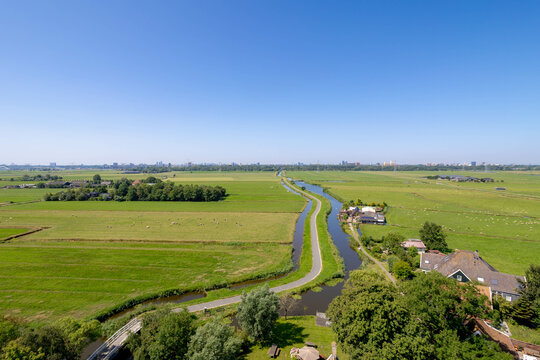 Typical Dutch polder in summer, Canal or ditch and green meadow, Overview from the top of Church tower in Ransdorp, A small village part of the municipality of Amsterdam, North Holland, Netherlands.