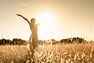 Joyful Person Raising Arms morning  in Rural Field Under Summer Sunlight - obrazy, fototapety, plakaty