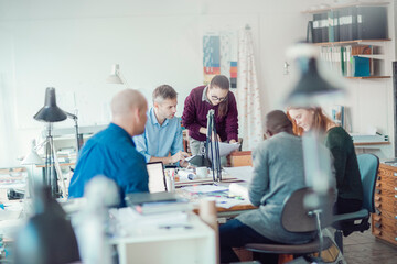 Group of people working together on a project in a startup company office