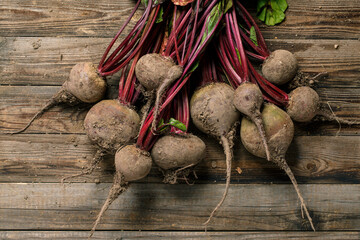 Freshly harvested red beets on a wooden table