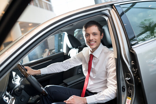 Young attractive seller in car
