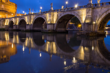 Castel Sant' Angelo and Ponte Sant' Angelo reflecting onto the River Tiber at twilight, Rome,...