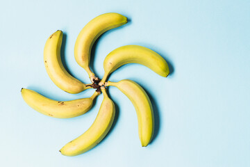 Fresh organic bananas on a blue background