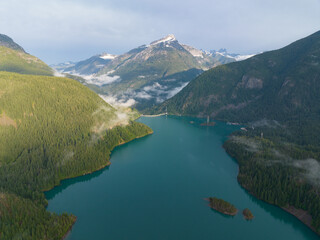 Obraz premium Rugged, forest-covered landscape surrounds Diablo Lake in North Cascades National Park. This mountainous region of northern Washington is absolutely beautiful and easily accessed during summer months.