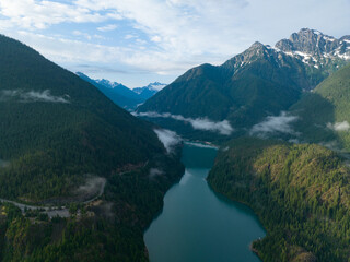 Obraz premium Rugged, forest-covered landscape surrounds Diablo Lake in North Cascades National Park. This mountainous region of northern Washington is absolutely beautiful and easily accessed during summer months.