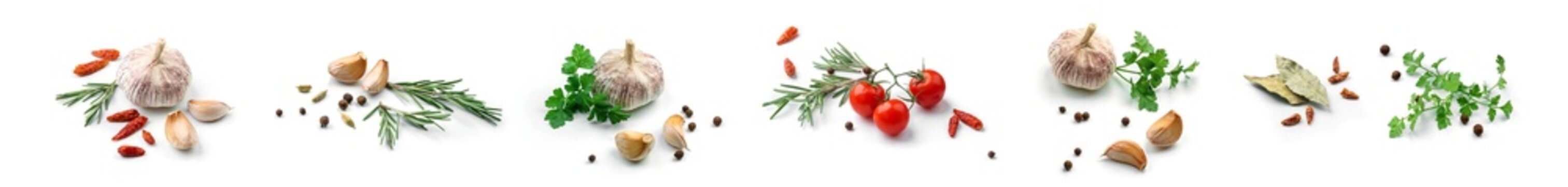 Set of fresh green herbs and spices isolated on white background, tomatoes, basil leaf, bay leaf, black pepper, rosemary, cardamom, cilantro, garlic, top view