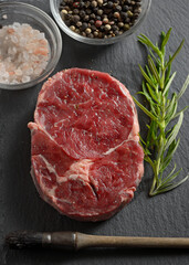 Fresh raw steak with salt and pepper