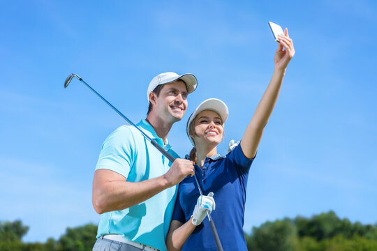 Young couple making selfie on a golf course