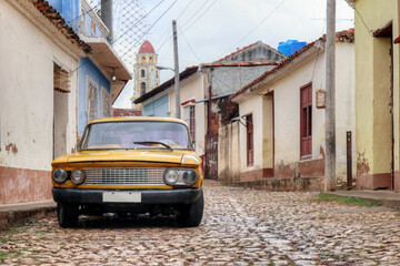 Old car sitting on a street of an old Cuban town