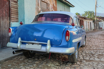 A Cuban retro car using as a Taxi parked on the street of the town of Trinidad 