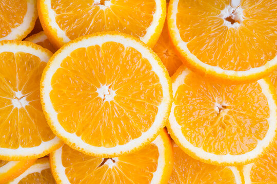 Fresh orange cut in many slices as background