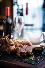 Mixed grilled meat platter. Assorted delicious grilled steaks served with goat cheese on warm dish.