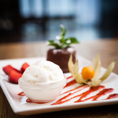 Chocolate fondant with a scoop of mint ice cream and cherry sauce
