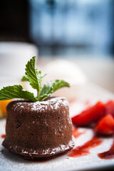 Chocolate fondant with a scoop of mint ice cream and cherry sauce