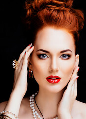 beauty stylish redhead woman with hairstyle and manicure wearing jewelry pearl close up