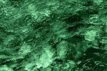 Abstract underwater wallpaper. Aquatic ripple wavy green water surface, water texture background, top view.