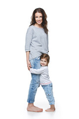 Fototapeta premium Beautiful young woman with little girl. Mother and daughter isolated over white background. Copy space.