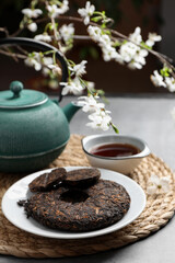 Fototapeta na wymiar Composition with aromatic pu-erh tea on grey table