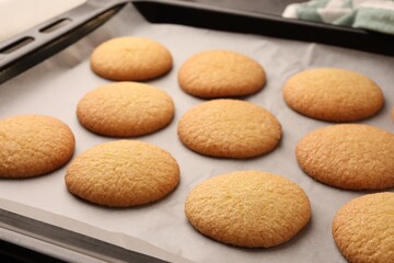 Delicious Danish butter cookies on baking tray, closeup