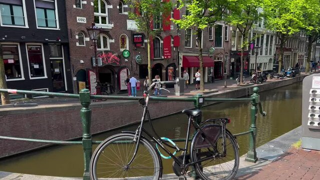 Traditional old narrow houses boats and canals Amsterdam, Netherlands, Europe, July 5 2023 . High quality 4k footage