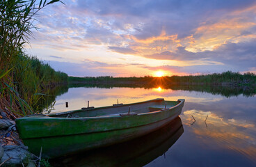 Fisherman boat on Danube Delta at sunset