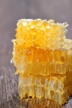 Honey with honeycombs on wooden background