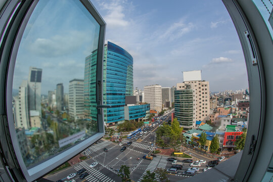 Wide angle shot of city panorama with intense car traffic on the streets. View from the window to Seoul, South Korea