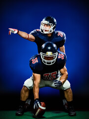 two american football players men isolated on colorful black background