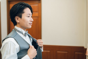 控え室・ブライズルームで結婚式・挙式・披露宴の準備をする新郎・花婿
