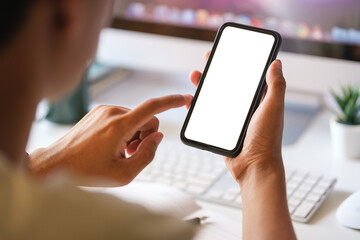 View over shoulder of man hands holding smart phone. Empty screen for your advertise text..