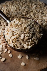 nigerian egusi seeds in a brown bowl, shelled melon seeds in a bowl, nigerian melon seeds, pumpkin seeds for cooking