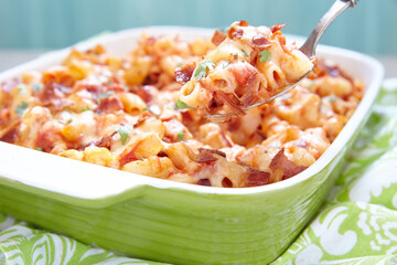 Pasta casserole with bacon, ham, cheese and tomato sauce