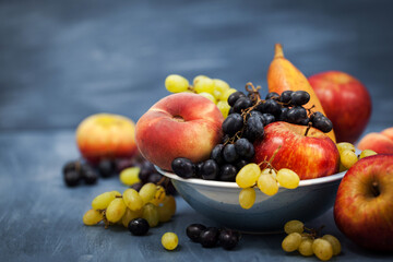 Fresh ripe autumnal fruits - peaches, pears, apples and grapes