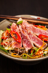Delicious grilled tuna and  asian rice glass noodles with vegetables