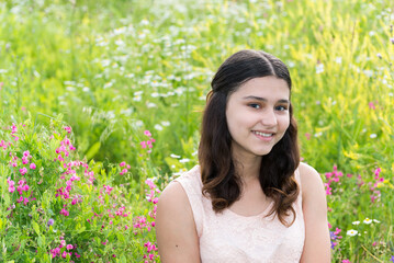 Naklejka na ściany i meble Portrait of a teen girl outdoors in summer