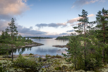 Ladoga lake bay and small islands at sunset warm light. Nature of Karelia republic, Russia.