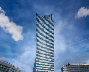 Obraz premium Modern residential skyscraper at dark blue sky. Copy space.