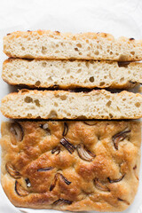 Top view of homemade onion focaccia on a white background, Flatlay of focaccia with red onion topping, fresh homemade focaccia bread