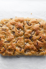 Top view of homemade onion focaccia on a white background, Flatlay of focaccia with red onion topping, fresh homemade focaccia bread