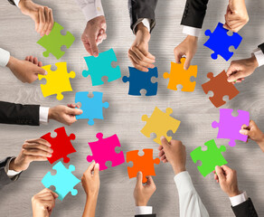 Business people join the colorful puzzle pieces