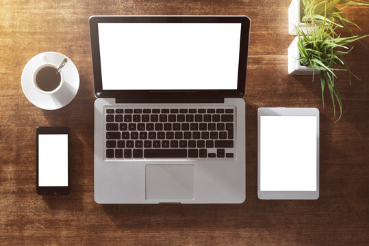 Corporate identity mock up on an hardwood desk with laptop, tablet, smartphone and a cup of coffee
