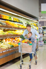 Smiling family with shopping cart