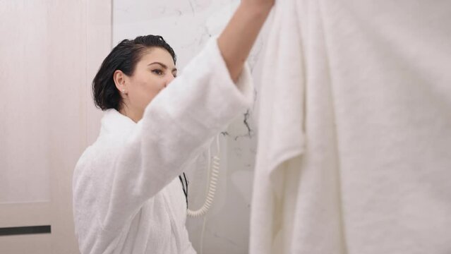 Wipes head, With towel, Fresh woman. After shower, young attractive woman dries damp hair and head with towel.